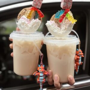 Pair of red/pink winged flexi dragons protecting a cool bucket drink.